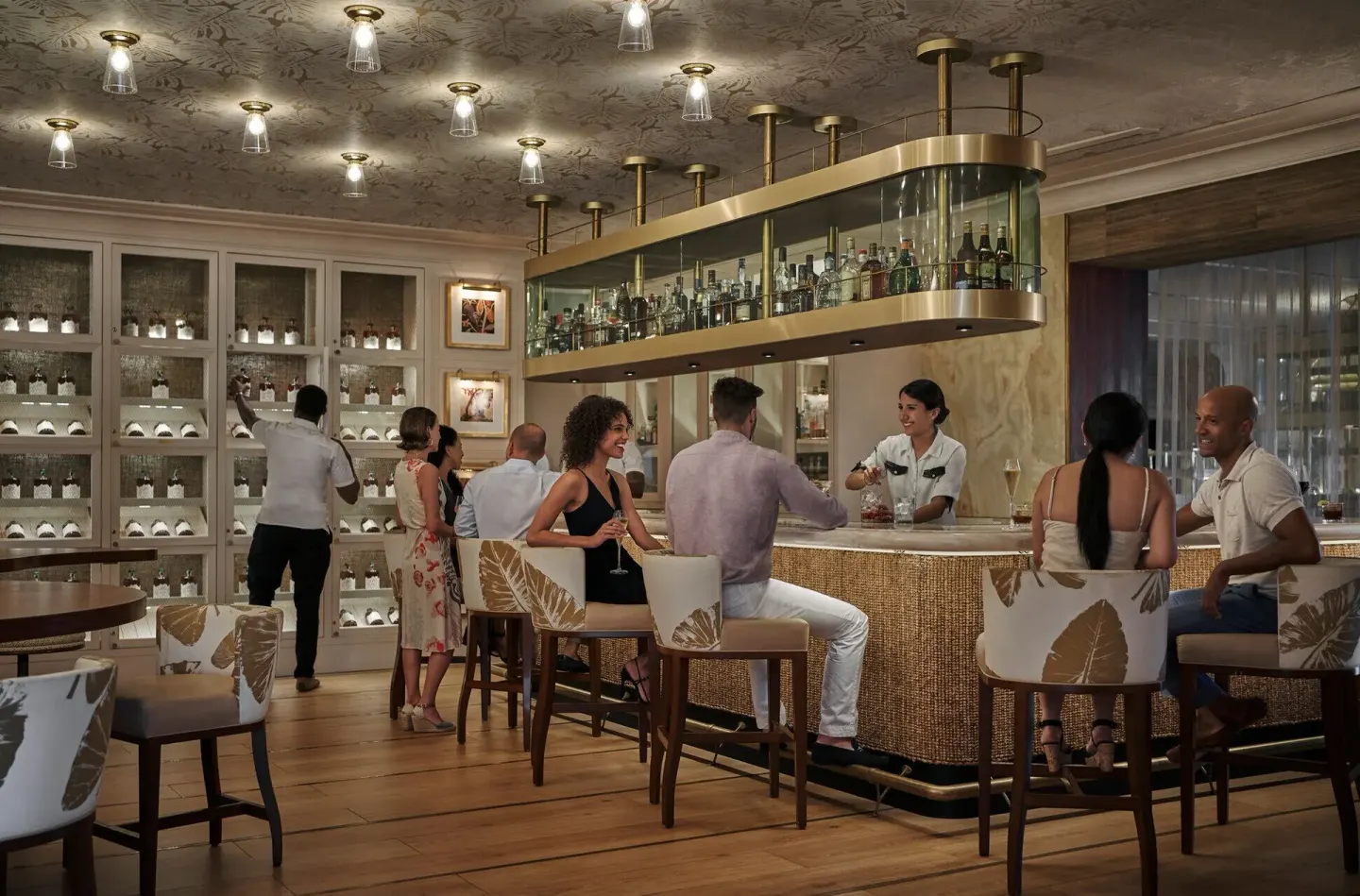 Guests seated at a rum bar inside Four Seasons Resort Nevis.