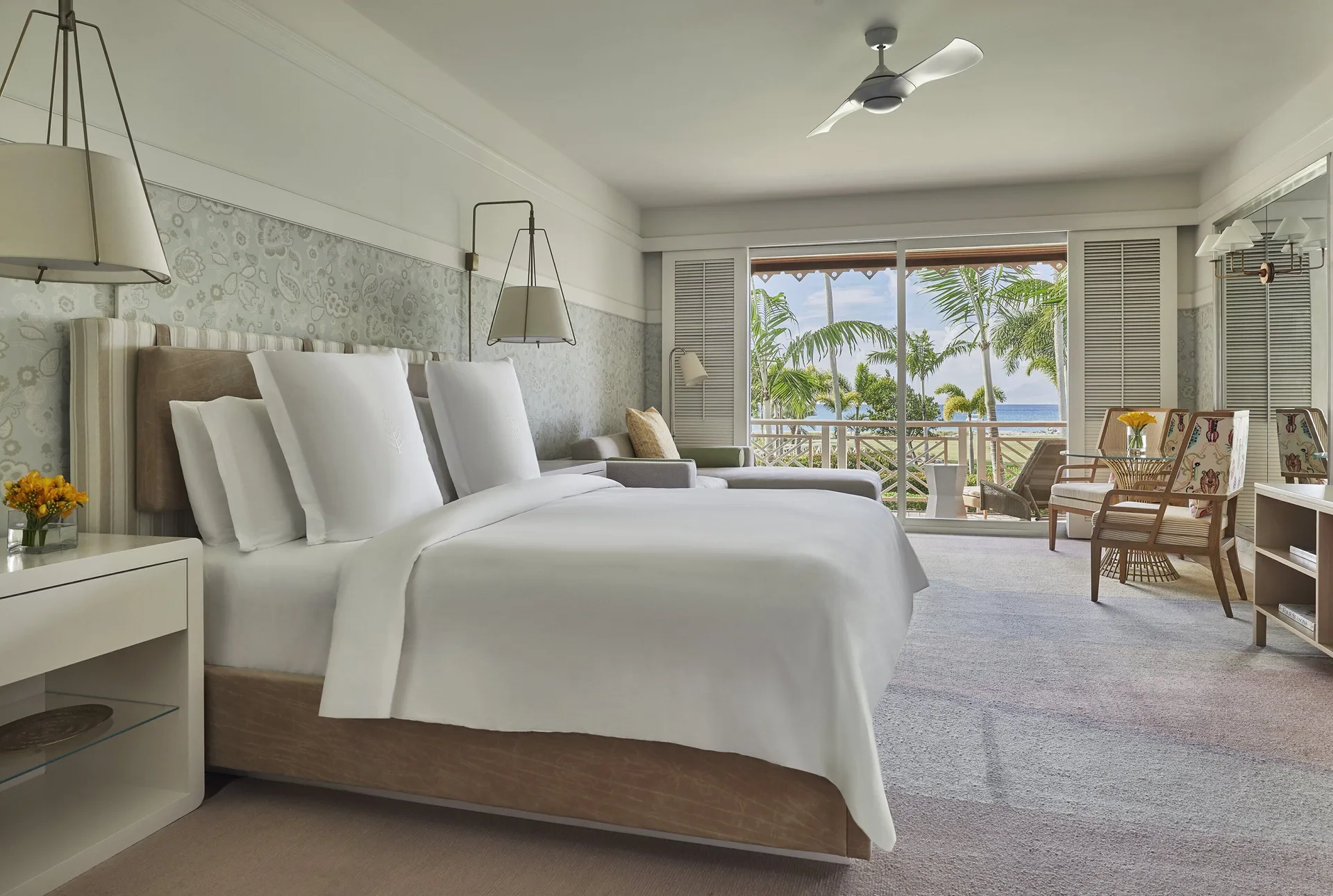 Alexander Suite bedroom with king bed and balcony view at Four Seasons Resort Nevis.