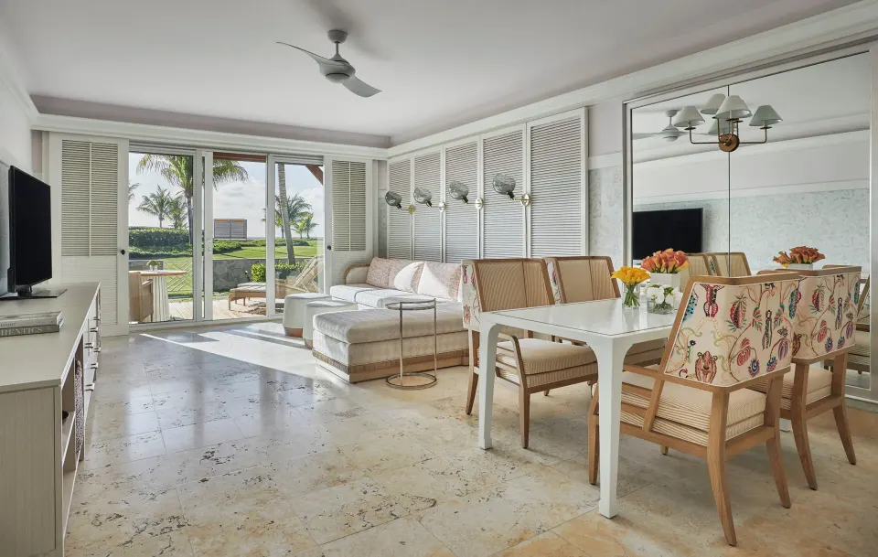 Chelanii Suite lounge and dining space with outdoor view at Four Seasons Resort Nevis.