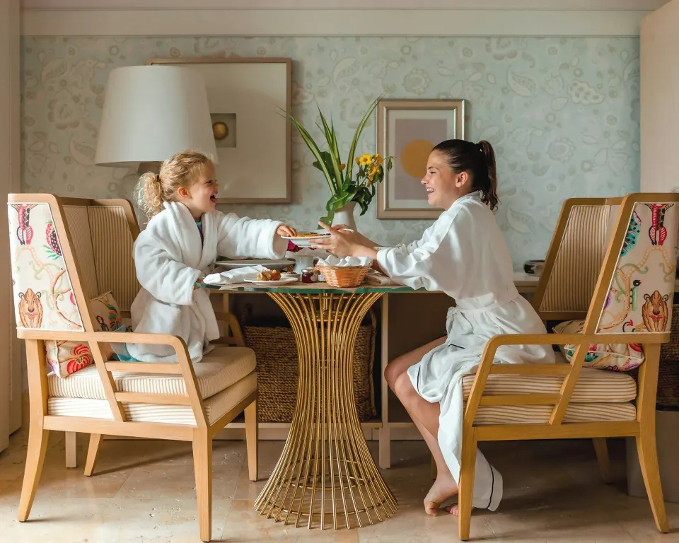 Nevis Peak View room dining table with two guests in robes at Four Seasons Resort Nevis.