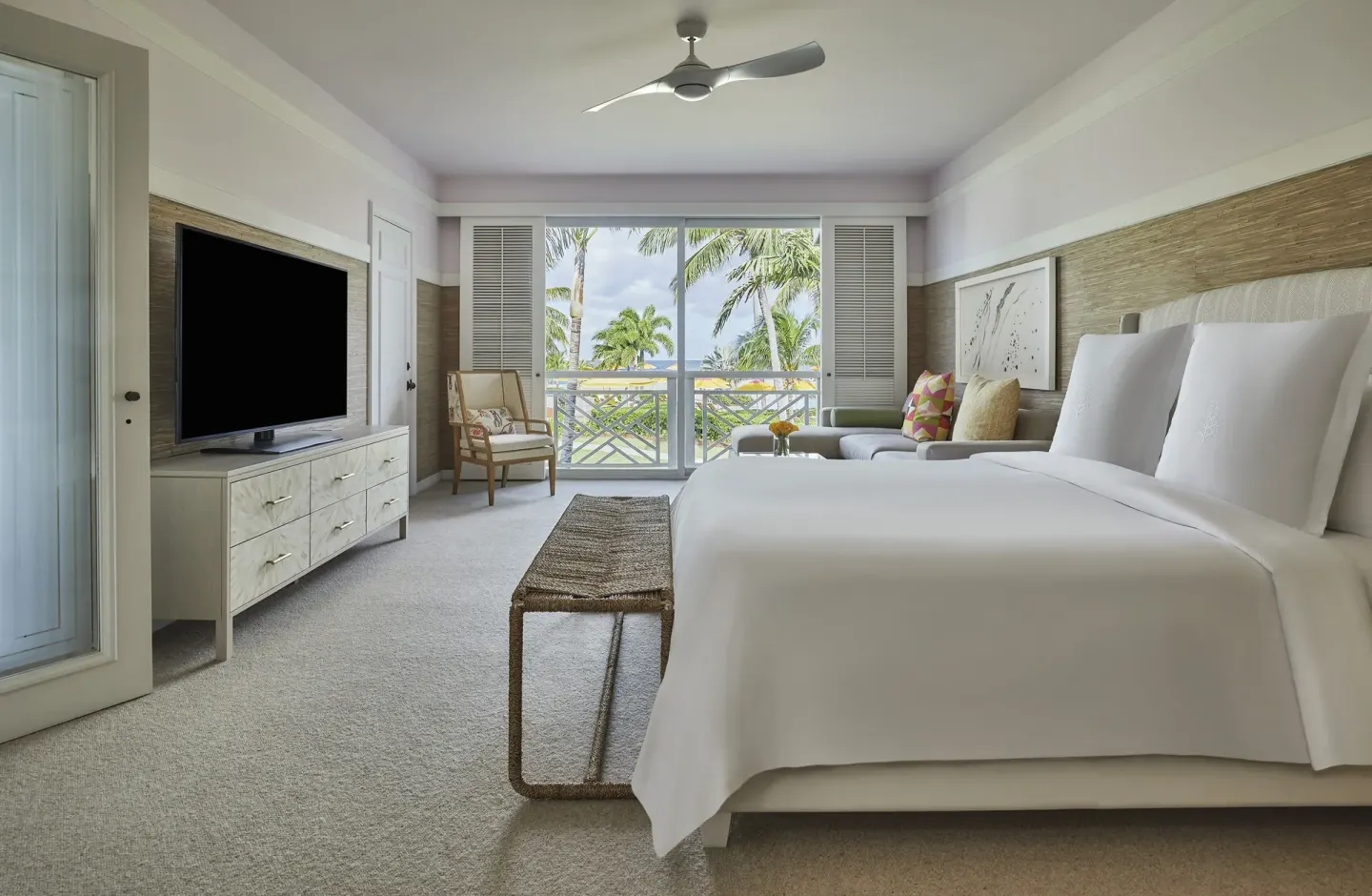 Poinciana Suite bedroom with king bed and balcony view at Four Seasons Resort Nevis.