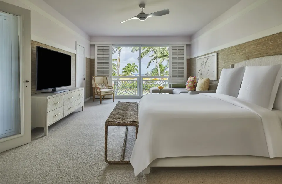 Poinciana Suite bedroom with king bed and balcony view at Four Seasons Resort Nevis.