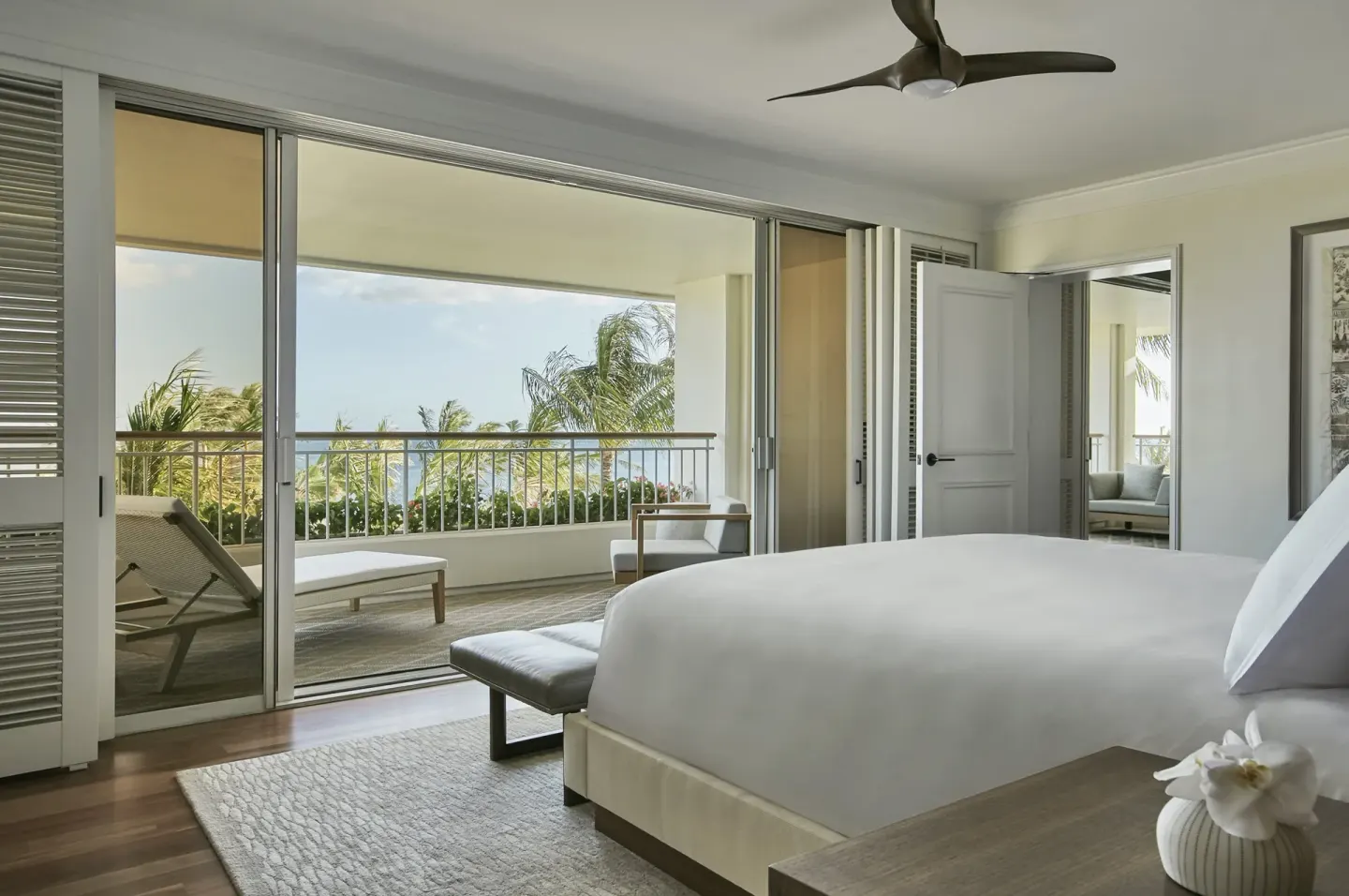 King bedroom opening to a lanai at Four Seasons Resort Oahu at Ko Olina.