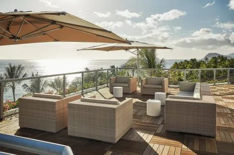 Ocean-view terrace seating at Four Seasons Resort Oahu at Ko Olina.
