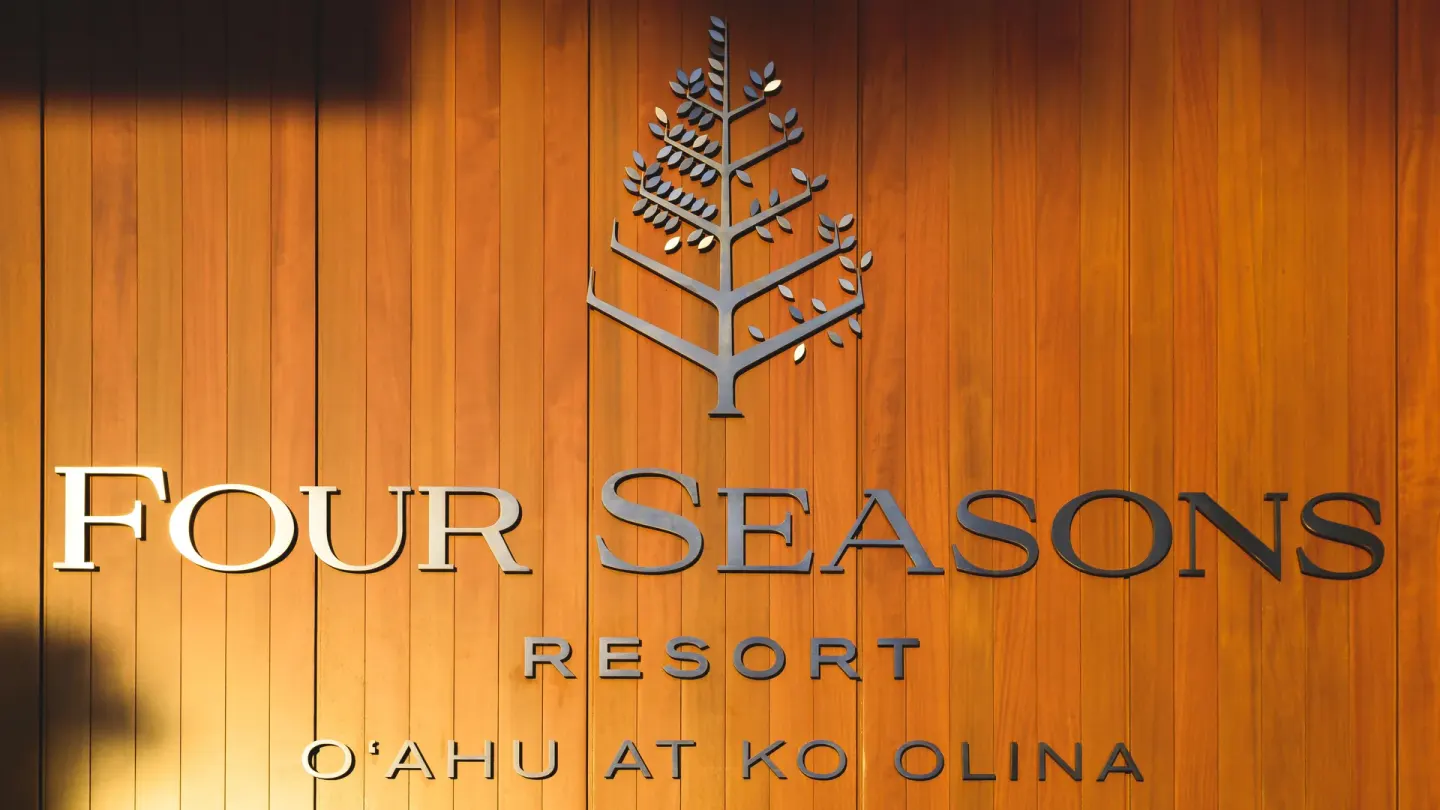 Four Seasons Resort Oahu at Ko Olina resort sign on a wood wall at Four Seasons Resort Oahu at Ko Olina.