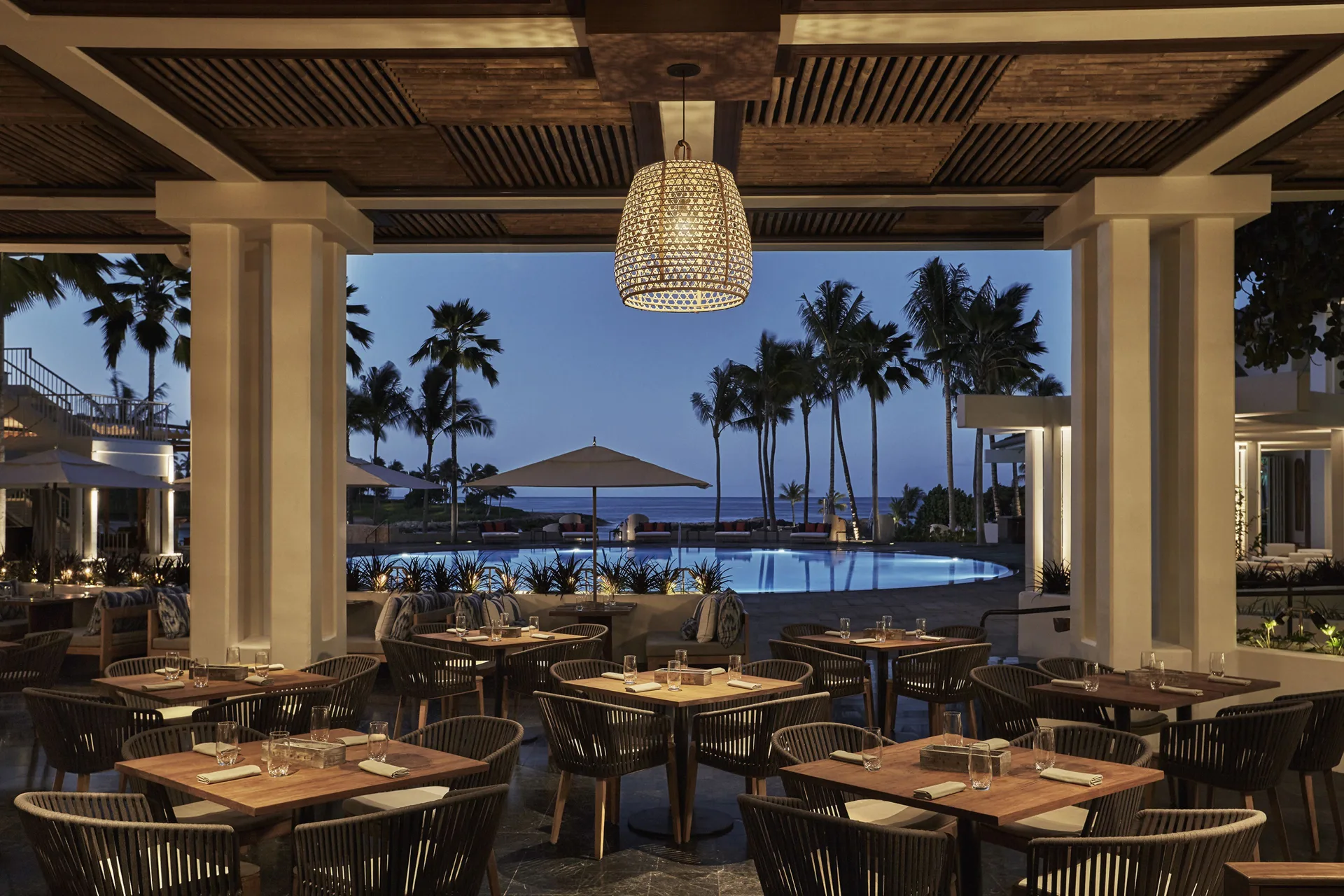 Evening poolside dining terrace at Four Seasons Resort Oahu at Ko Olina.
