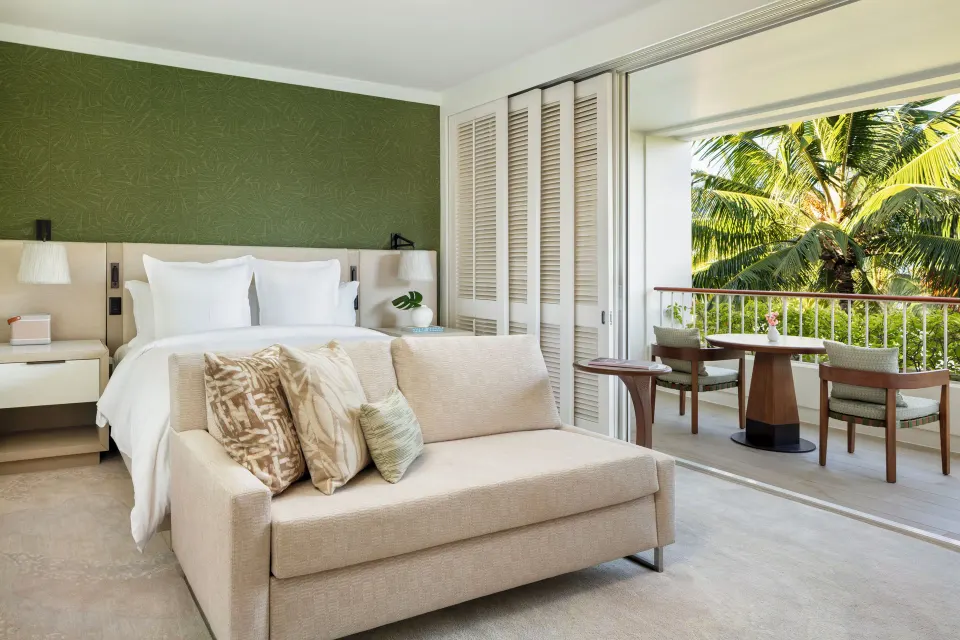 Club Partial Ocean Room king bed, sofa, and lanai at Four Seasons Resort Oahu at Ko Olina.
