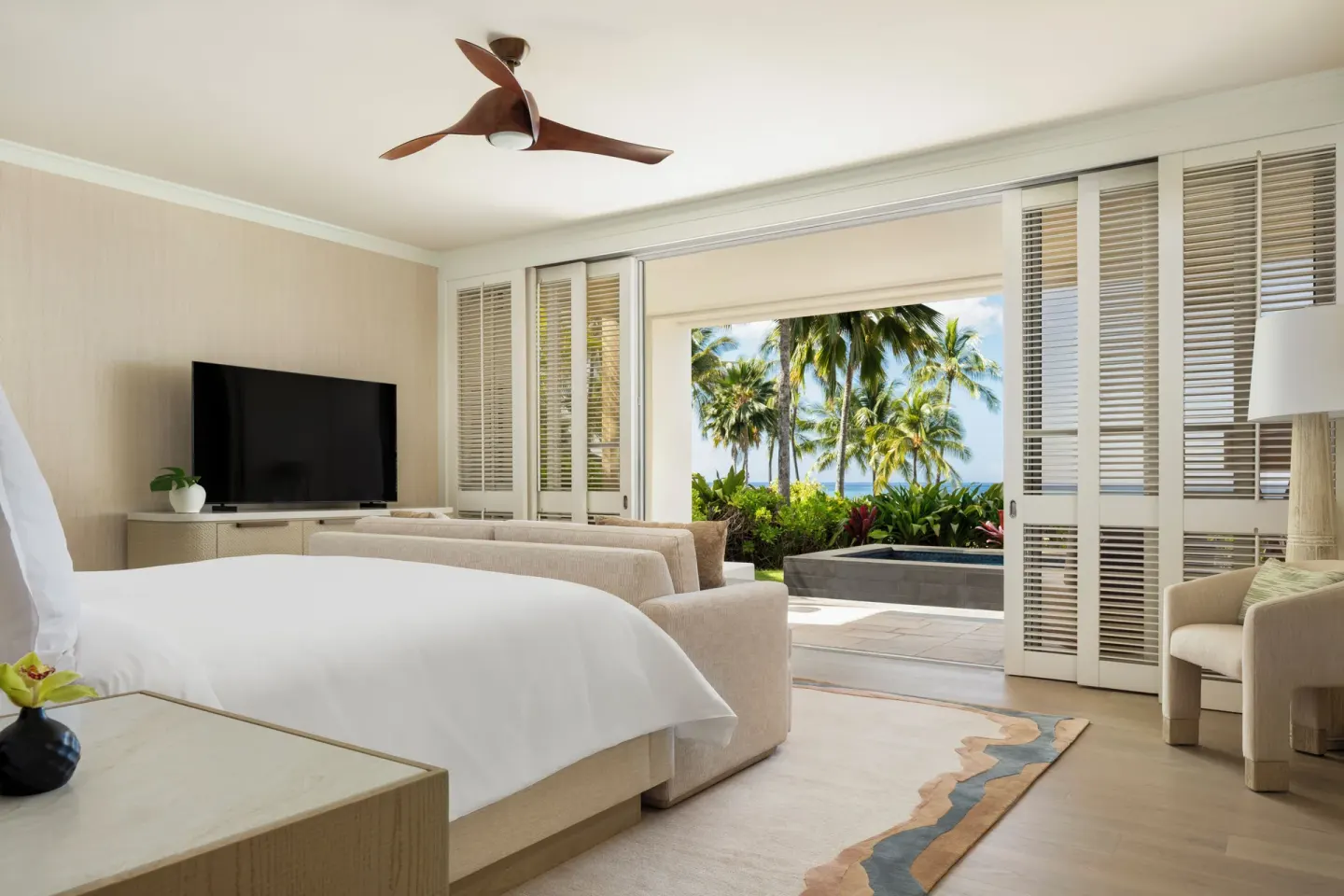 Pacific Suite bedroom at Four Seasons Resort Oahu at Ko Olina with king bed, sofa and garden terrace.
