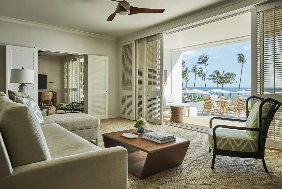 Pacific Suite living room at Four Seasons Resort Oahu at Ko Olina with doors open to oceanfront terrace.