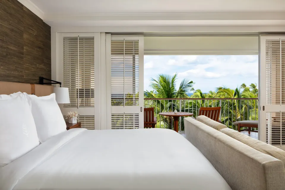 Partial Ocean Room king bed and balcony at Four Seasons Resort Oahu at Ko Olina.