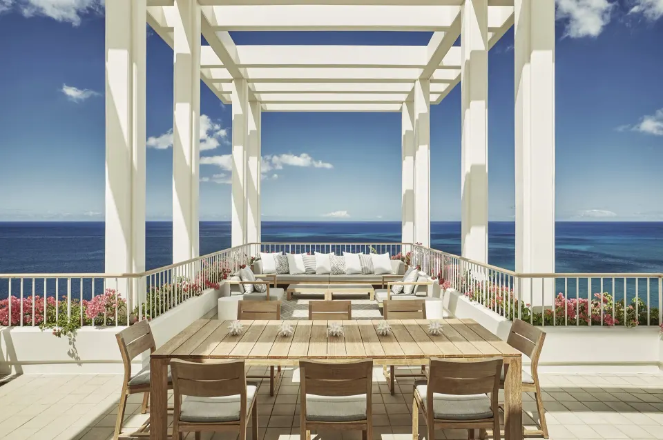 Penthouse Suite terrace dining table and lounge at Four Seasons Resort Oahu at Ko Olina.