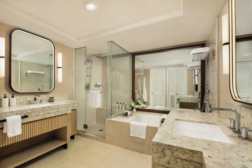 Resort Room bathroom with tub, shower and dual vanities at Four Seasons Resort Oahu at Ko Olina.