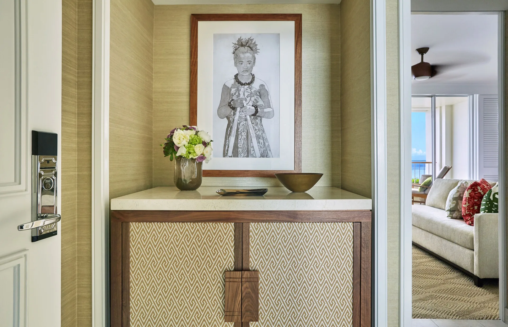 Resort Room entry with artwork and a sofa at Four Seasons Resort Oahu at Ko Olina.