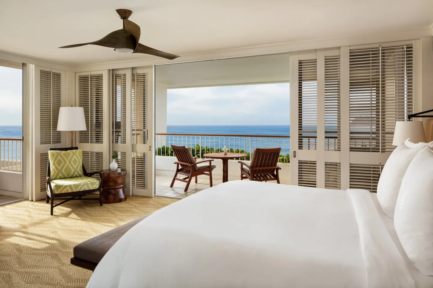 Oceanfront prime corner guest room with king bed and lanai at Four Seasons Resort Oahu at Ko Olina.