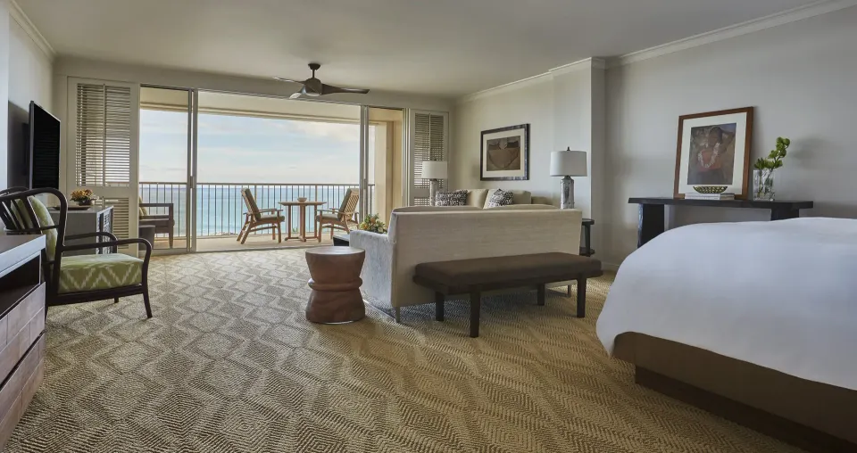 Studio Suite Oceanfront bed and seating area at Four Seasons Resort Oahu at Ko Olina.