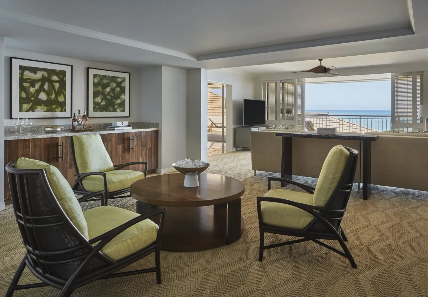 Residence living room with wet bar and ocean-facing balcony at Four Seasons Resort Oahu at Ko Olina.