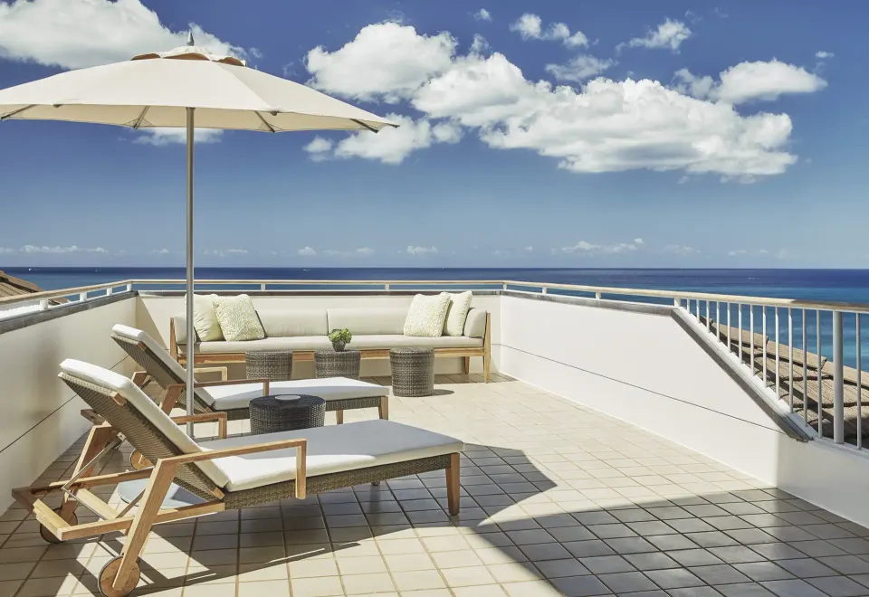 Private Residence terrace with loungers and ocean view at Four Seasons Resort Oahu at Ko Olina.