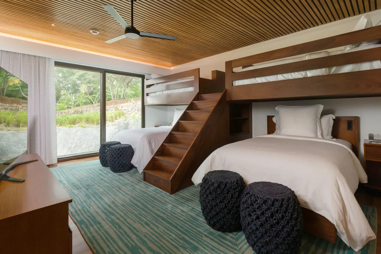 Bunk room with twin beds and upper bunks at Four Seasons Resort Peninsula Papagayo, Costa Rica.