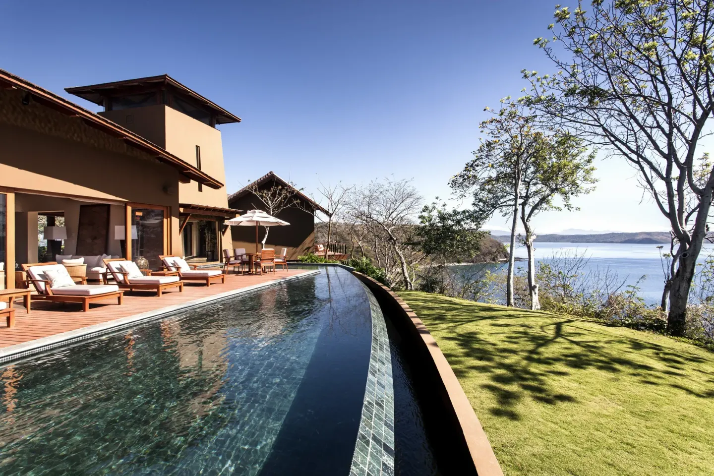 Curved infinity pool beside a villa at Four Seasons Resort Peninsula Papagayo, Costa Rica.