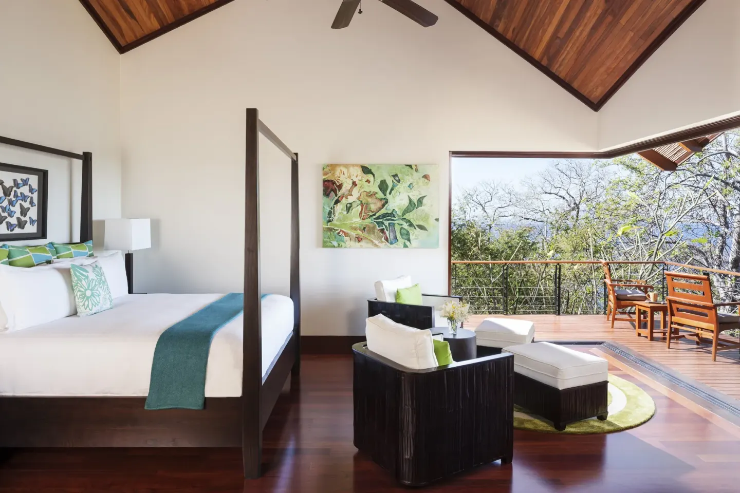 Guest room with four-poster king bed and balcony at Four Seasons Resort Peninsula Papagayo, Costa Rica.