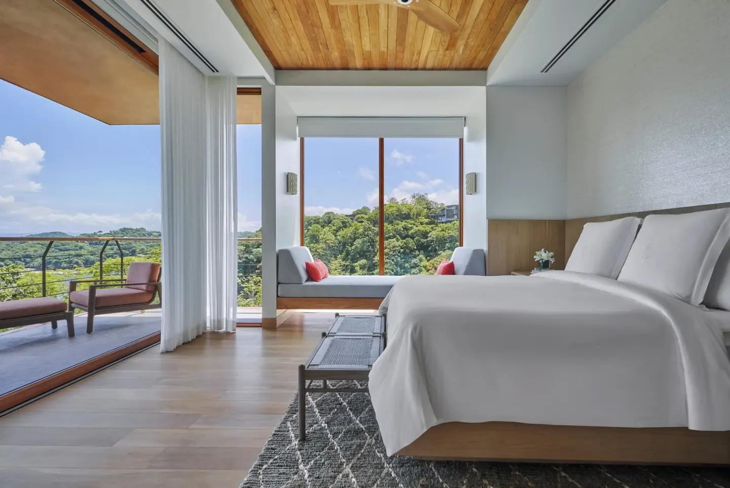 King bed guest room with balcony view at Four Seasons Resort Peninsula Papagayo, Costa Rica.