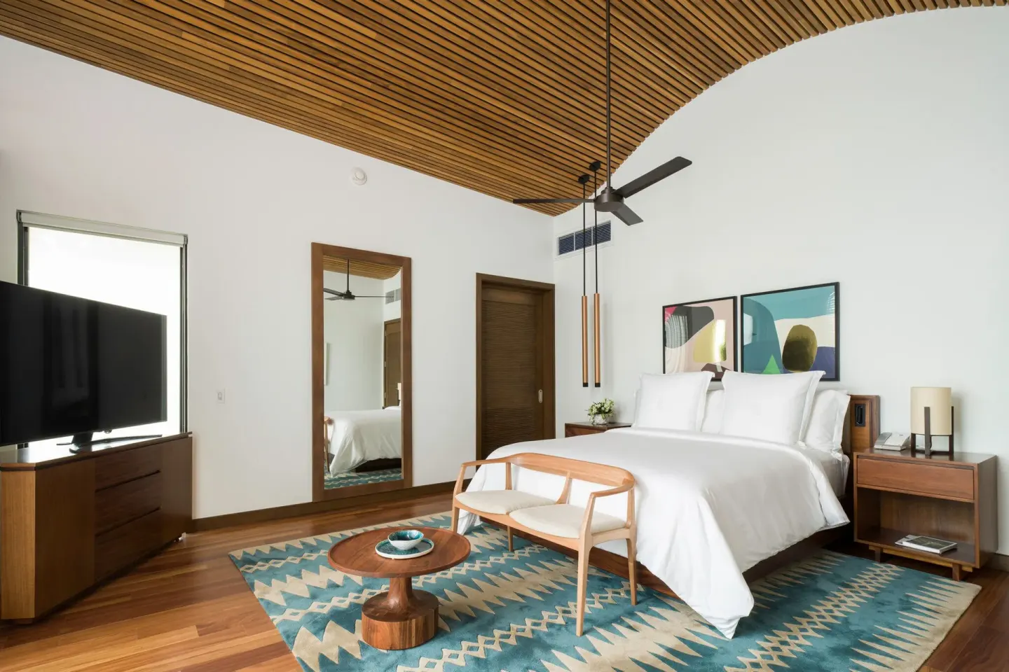 Guest room with king bed and wood ceiling at Four Seasons Resort Peninsula Papagayo, Costa Rica.