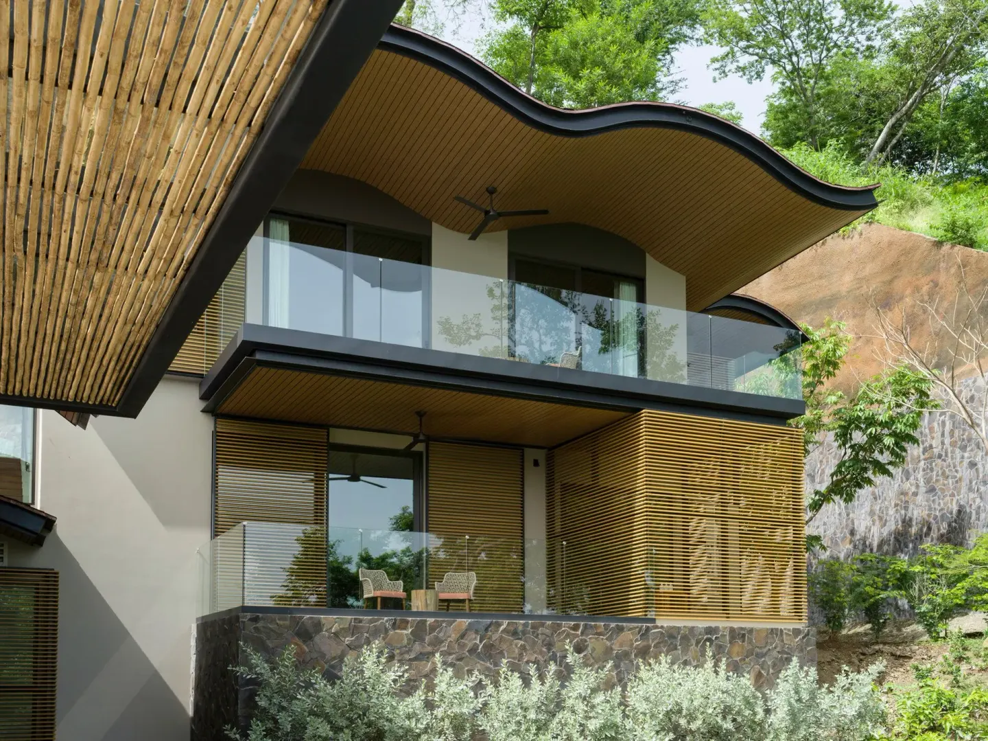 Modern guest building with glass balconies at Four Seasons Resort Peninsula Papagayo, Costa Rica.