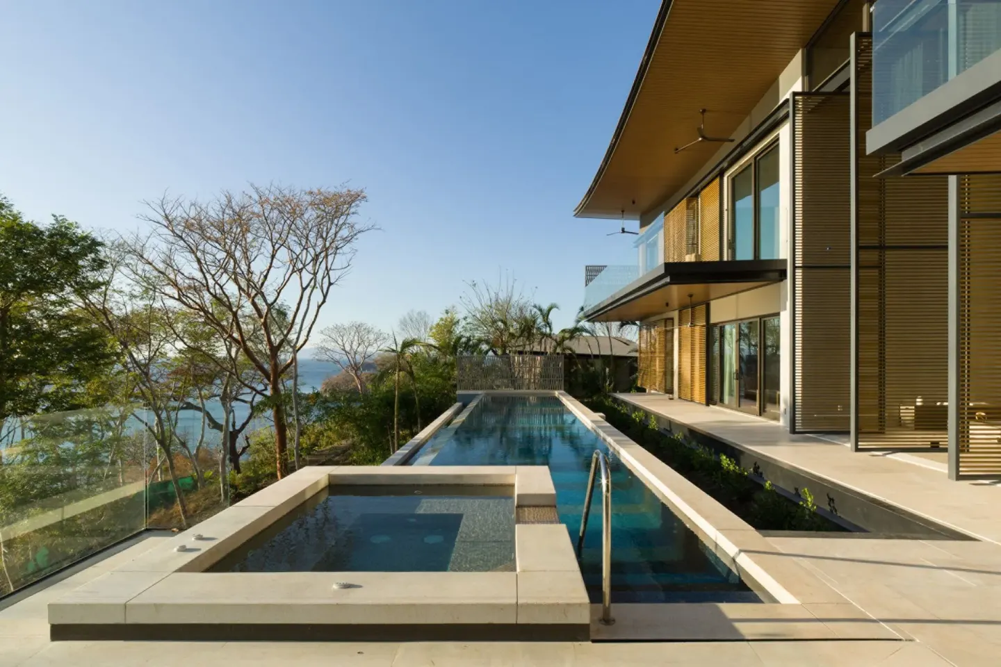 Long outdoor pool beside a modern villa at Four Seasons Resort Peninsula Papagayo, Costa Rica.