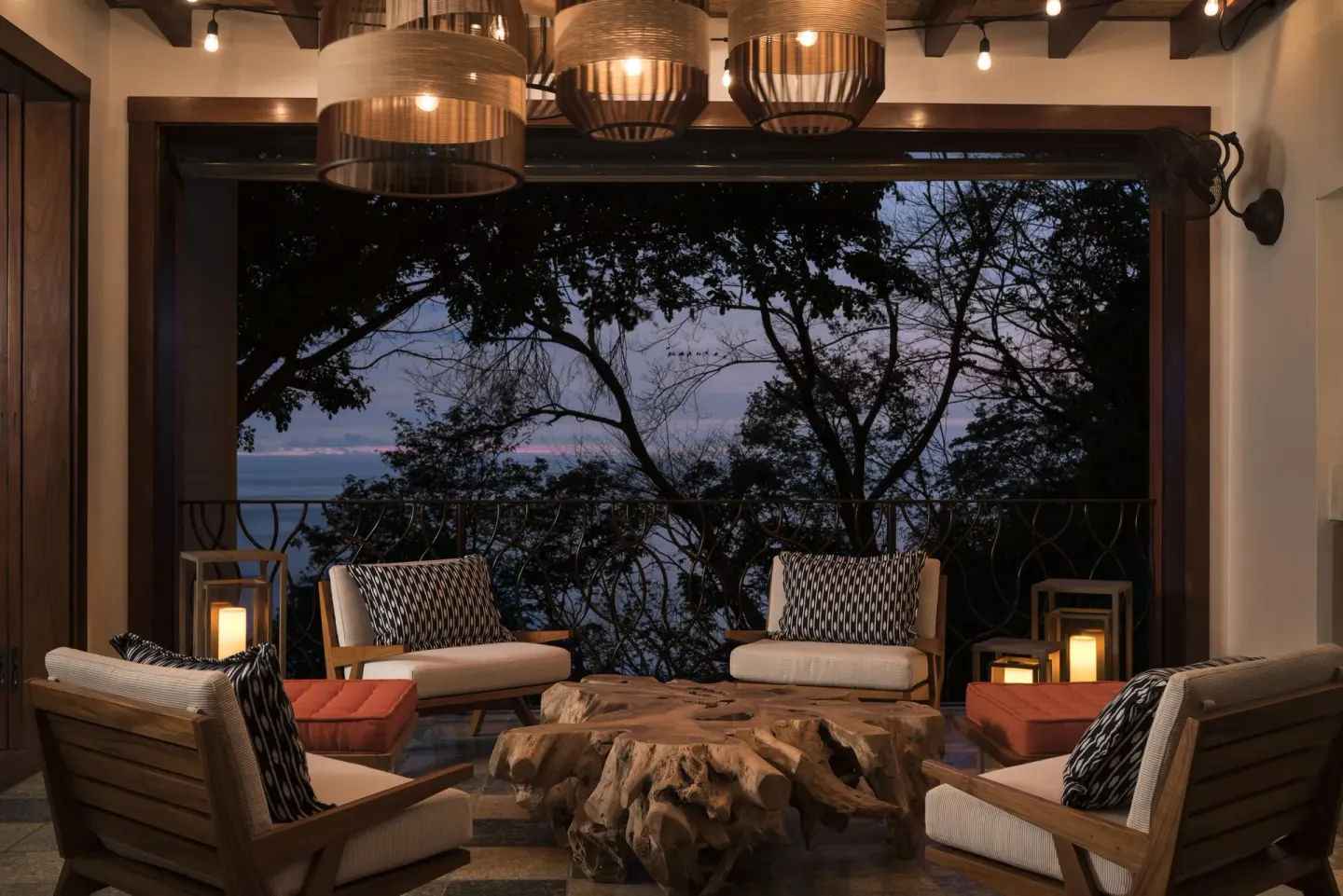 Open-air lounge with cushioned chairs and ocean view at Four Seasons Resort Peninsula Papagayo, Costa Rica.