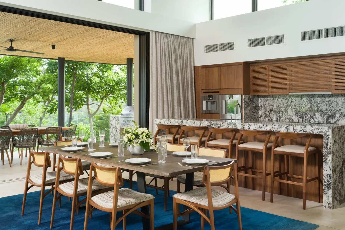 Open dining room and kitchen leading to a terrace at Four Seasons Resort Peninsula Papagayo, Costa Rica.