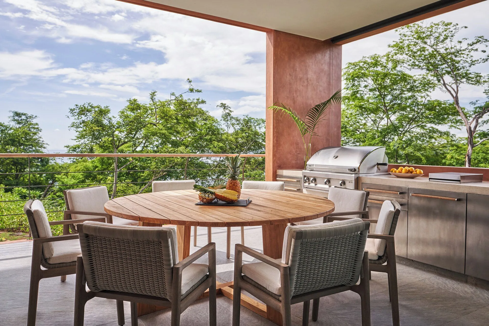 Outdoor dining terrace with grill and round table at Four Seasons Resort Peninsula Papagayo, Costa Rica.