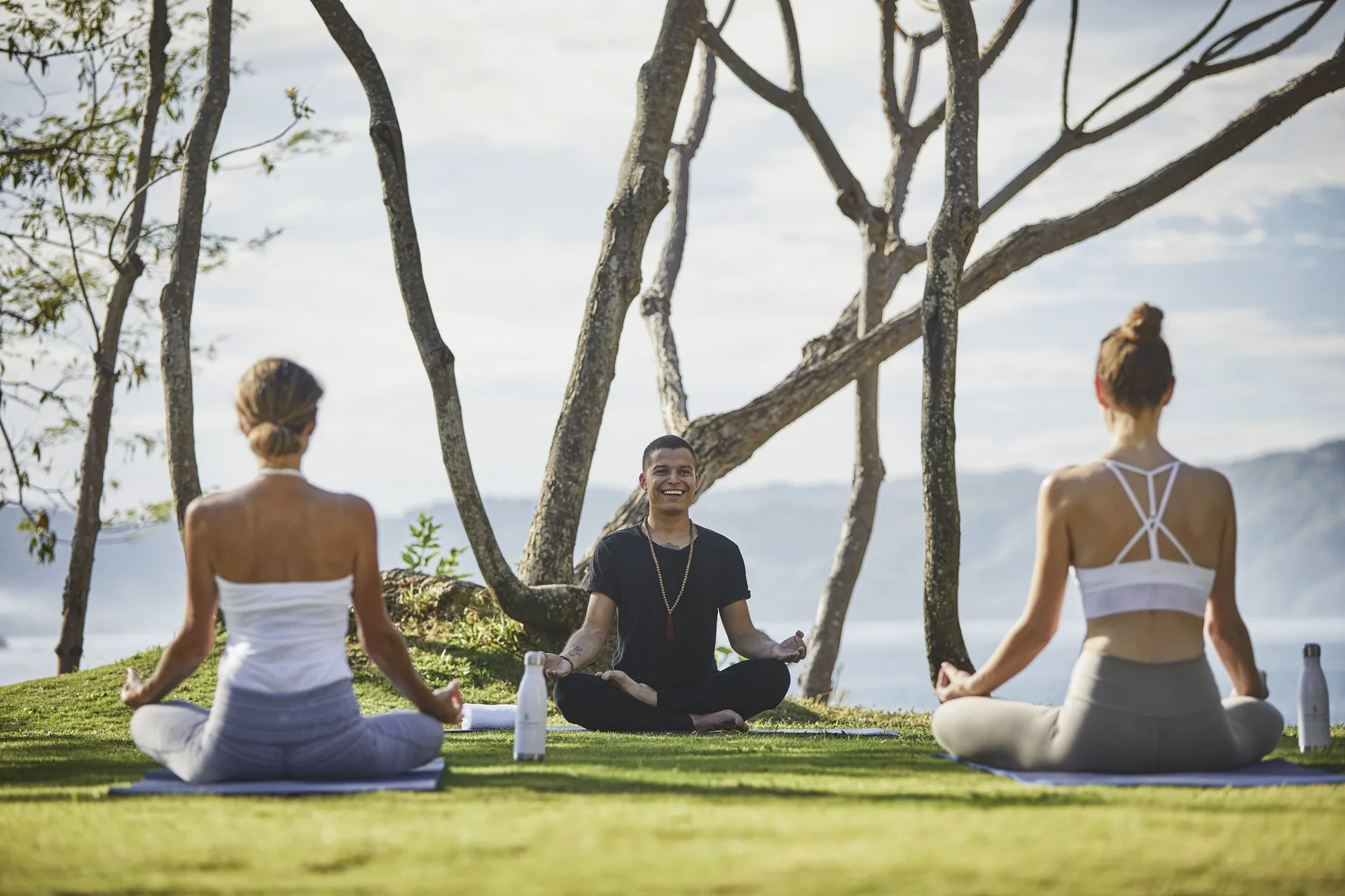 Outdoor yoga session on the lawn at Four Seasons Resort Peninsula Papagayo, Costa Rica.