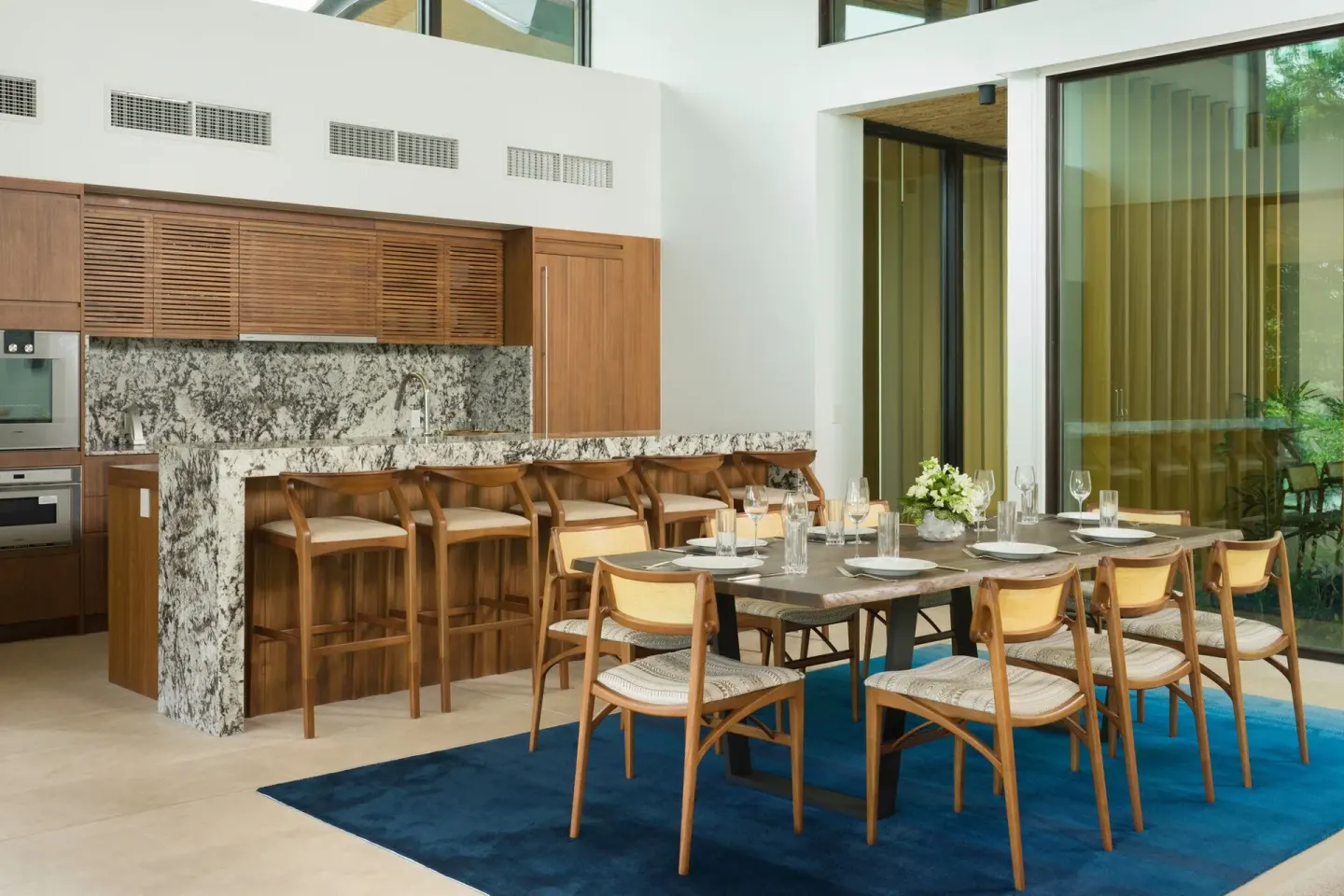 Villa dining area and kitchen with wood cabinetry at Four Seasons Resort Peninsula Papagayo, Costa Rica.