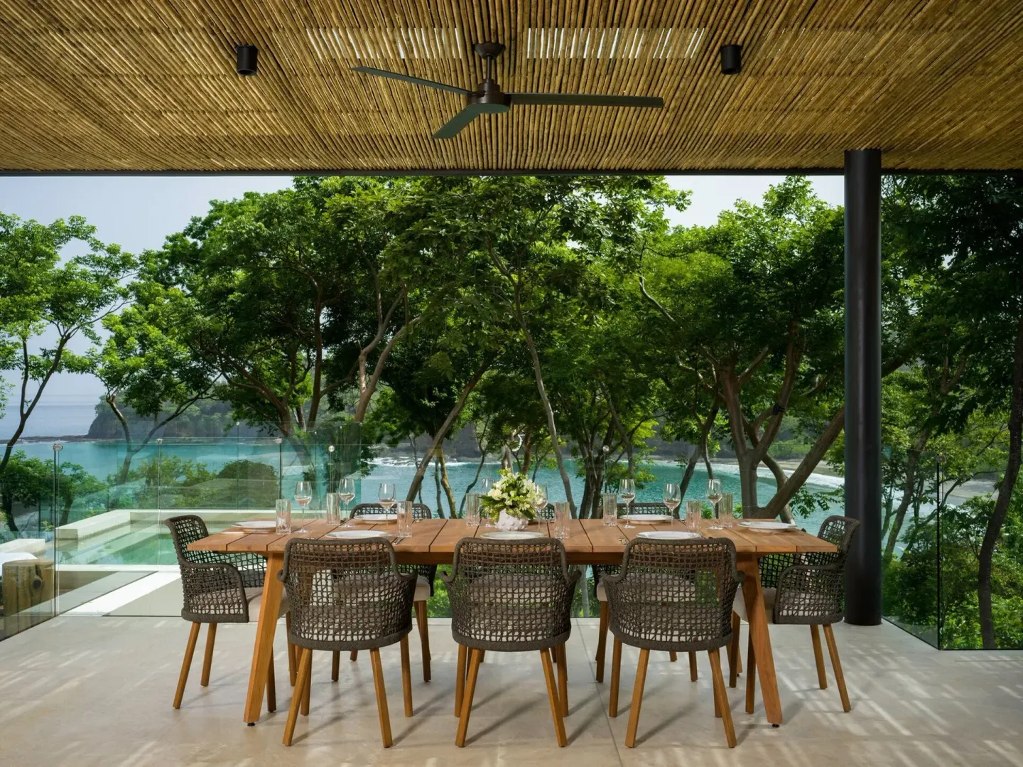 Outdoor dining table with bay views at Four Seasons Resort Peninsula Papagayo, Costa Rica.