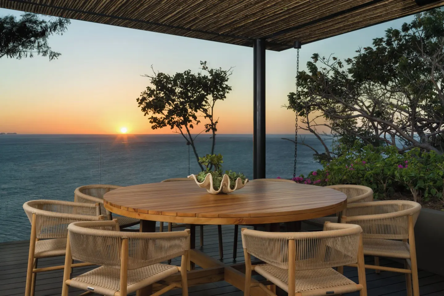 Outdoor dining table at sunset at Four Seasons Resort Peninsula Papagayo, Costa Rica.