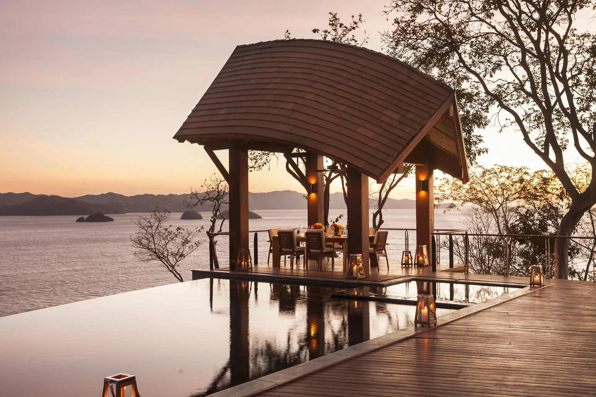 Sunset dining pavilion by an infinity pool at Four Seasons Resort Peninsula Papagayo, Costa Rica.