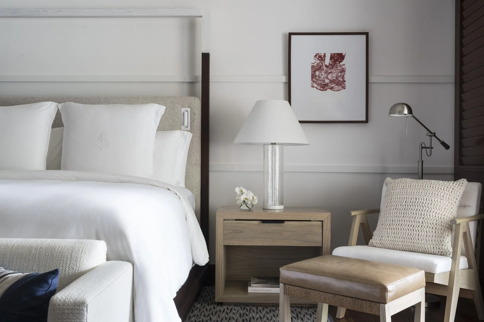 King bed, nightstand and lounge chair in a guest room at Four Seasons Resort Peninsula Papagayo, Costa Rica.
