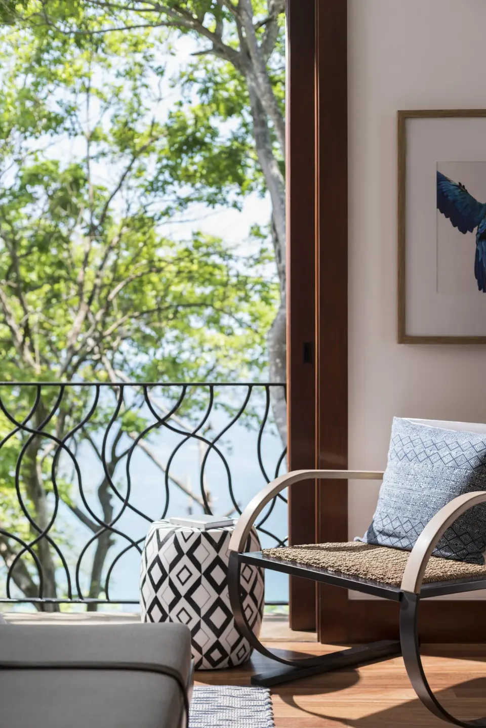 Guest room sitting area beside a balcony rail at Four Seasons Resort Peninsula Papagayo, Costa Rica.