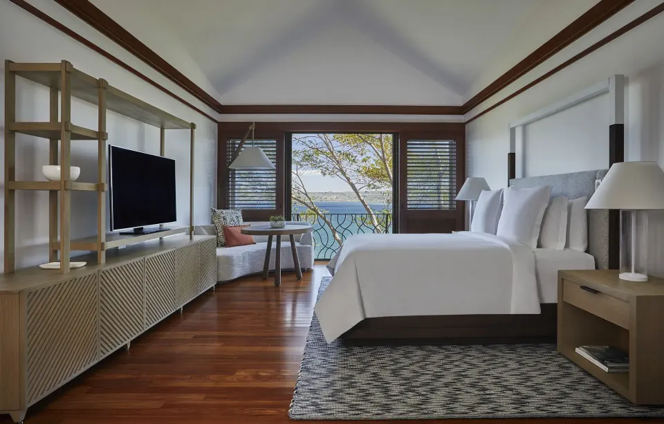 Canopy one-bedroom suite with king bed, TV, and water view at Four Seasons Resort Peninsula Papagayo, Costa Rica.