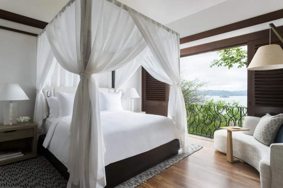 Pacifico Residence canopy bed and balcony view at Four Seasons Resort Peninsula Papagayo, Costa Rica.
