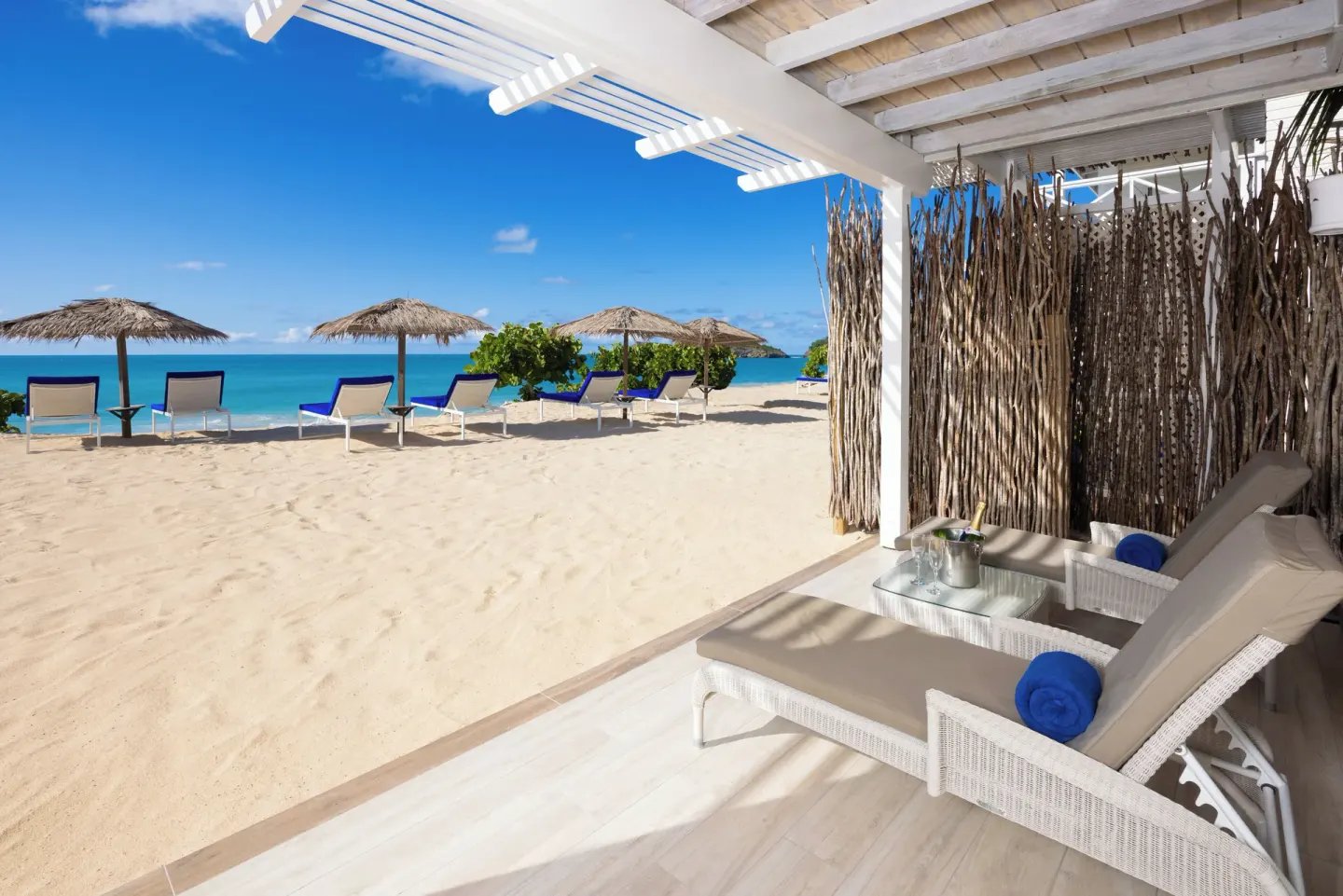 Beach cabana with loungers facing the sea at Galley Bay Resort & Spa.