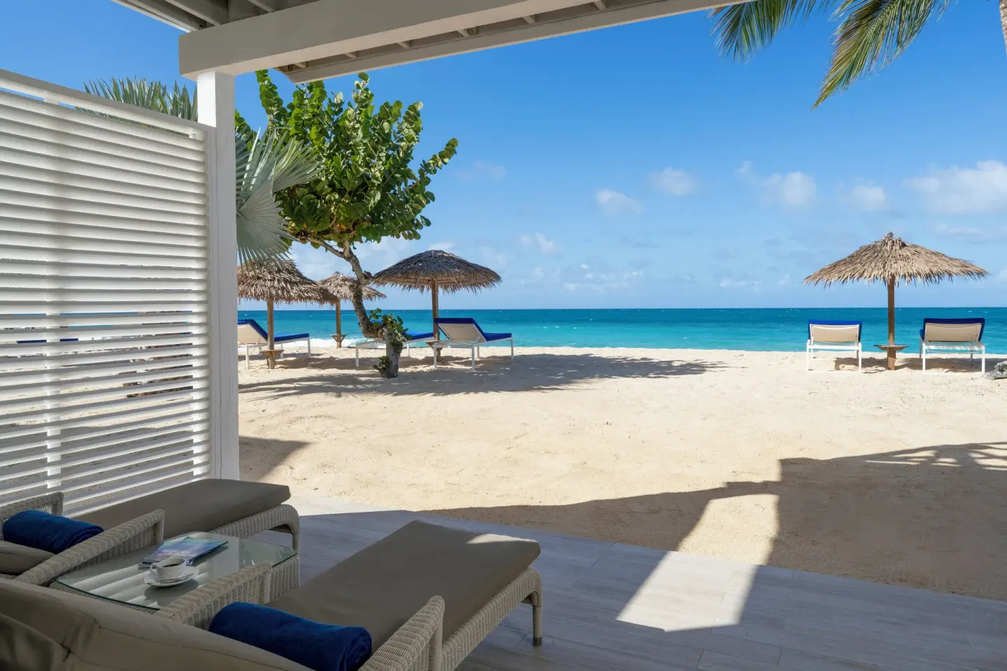 Beachfront patio with lounge seating opening directly onto sand at Galley Bay Resort & Spa.