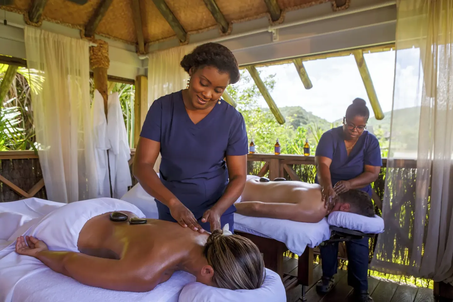 Massage therapists giving outdoor treatments at Galley Bay Resort & Spa.