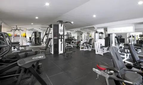 Fitness room with cardio machines, weights, and resistance equipment at Galley Bay Resort & Spa.
