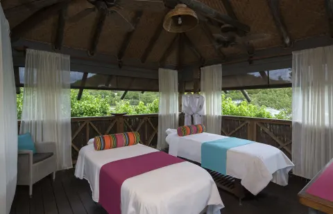Open-air spa pavilion with two treatment beds at Galley Bay Resort & Spa.