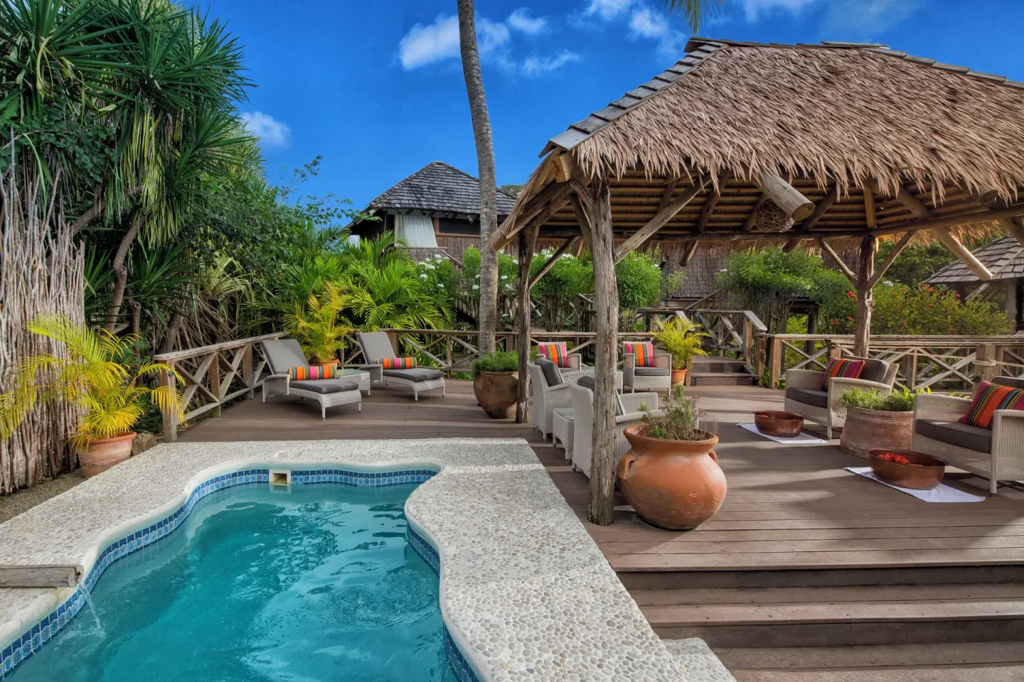 Small pool beside a thatched deck lounge at Galley Bay Resort & Spa.
