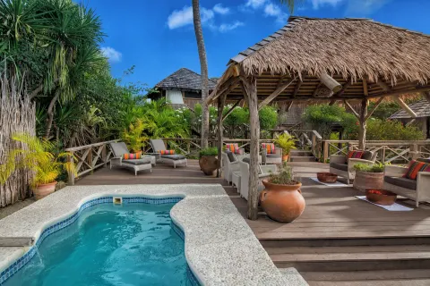 Small pool beside a thatched deck lounge at Galley Bay Resort & Spa.