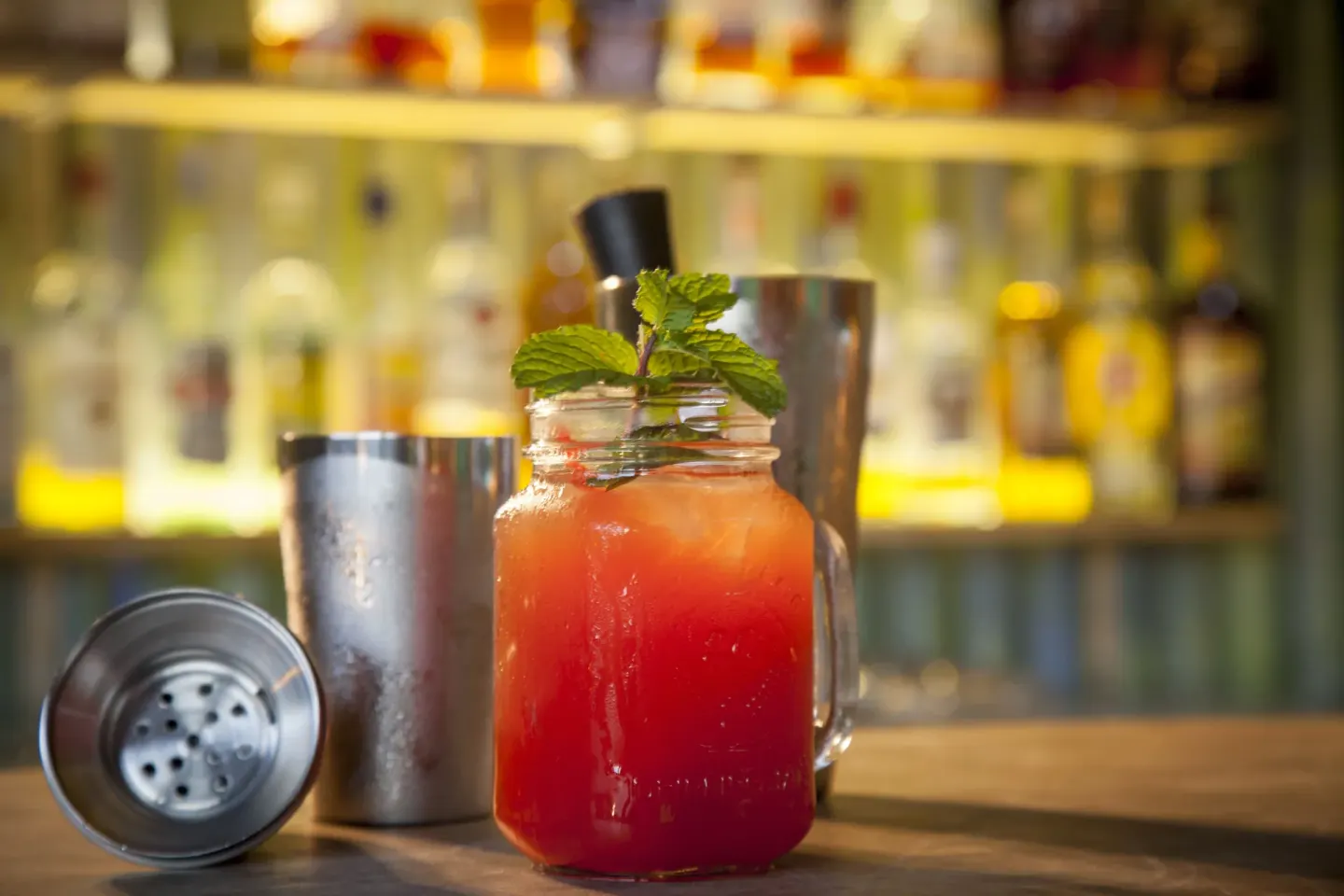 Colorful cocktail with mint beside shakers at Galley Bay Resort & Spa.