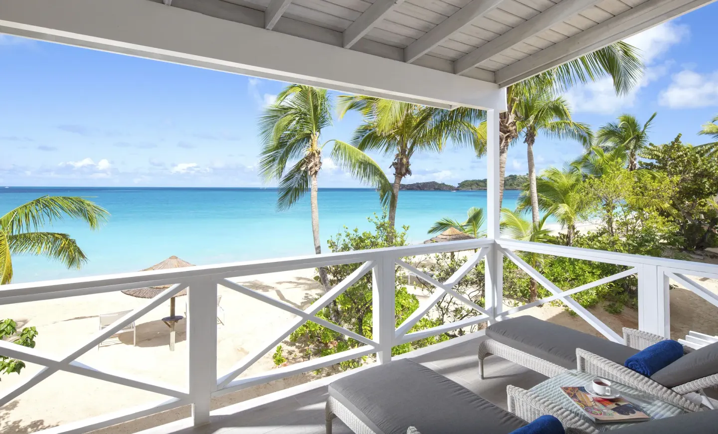 Deluxe Beachfront balcony loungers overlooking the sea at Galley Bay Resort & Spa.