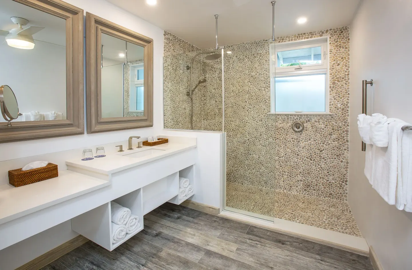 Deluxe Beachfront bathroom with double vanity and pebble shower at Galley Bay Resort & Spa.